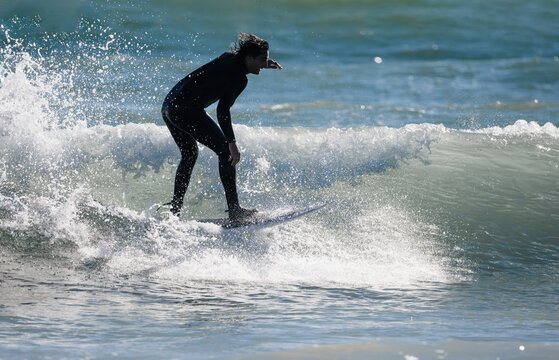 Surfer riding a wave on a sunny day