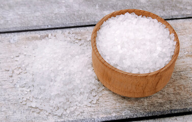 Sea salt on a wooden table. Coarse sea salt for cooking.