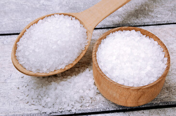 Sea salt on a wooden table. Coarse sea salt for cooking.