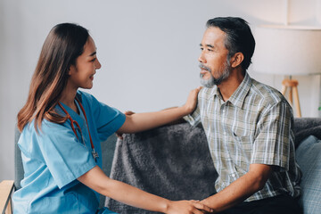 Fototapeta premium Speed Up Recovery From Injuries or Illness with Physical Therapy for Seniors. A female physiotherapist in-home care visit to massage muscle tension in the body or sprain 