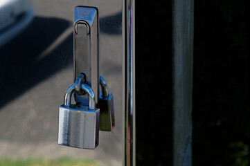 A padlock's shackle or shank fits tightly through a catch to secure it