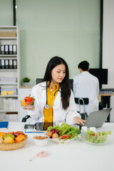 Professional nutritionist reviewing fresh vegetables and supplements for diet planning, health care,