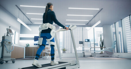 Woman in a Futuristic Medical Lab Uses an Advanced Exoskeleton on a Treadmill for Physical Rehabilitation, High-Tech Technology and Innovative Research in Recovery Techniques