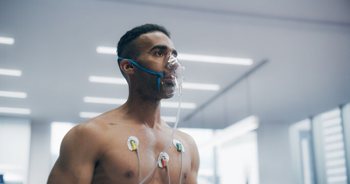 Athlete Wearing Oxygen Mask for a Treadmill Exercise Test in a Laboratory, Monitored by Sensors and Breathing Apparatus, Showcasing Fitness Assessment and Health Monitoring in a Controlled Environment