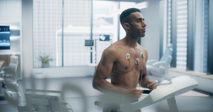 Athlete Performs Treadmill Exercise Test in a High-tech Medical Lab, Monitored by Sensors, Showcasing Advanced Fitness Evaluation and Health Monitoring