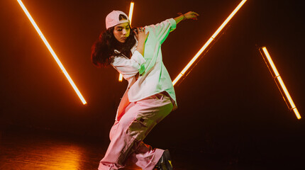 Hip hop dancer dancing in a cool studio with neon lights.