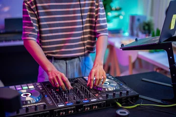 Fotobehang Close up of man artist DJ mixing and scratching music mixer controller.  © Kawee