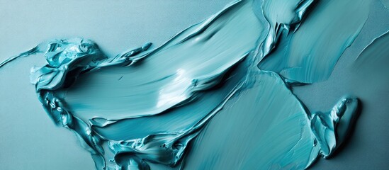 Turquoise acrylic paint texture flowing over a smooth teal background with natural blending and soft brushstrokes creating a serene artistic effect.
