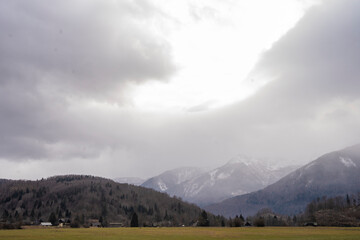 Bohinj lake with forest covered mountains in Julian Alps in winter. Popular touristic destination...