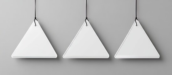 Triangular labels hanging from black strings against a light gray background, perfect for showcasing custom designs in a versatile display.