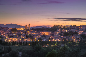 Urbino city skyline after sunset. Marche region, Italy.