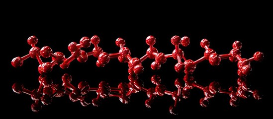 Red molecular structure on a black background with reflections, showcasing spheres connected by lines creating a dynamic scientific composition.