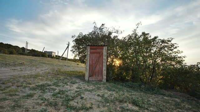 Village restroom in the evening at sunset.