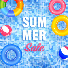 Colorful inflatable rings and beach balls floating on swimming pool advertising summer sale