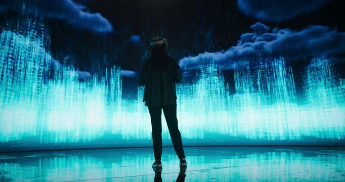 Female Urban Designer Immersed in Virtual Reality, Reimagines a Futuristic City. Virtual Production LED Wall Displays a Cityscape Polygon Model that is Transformed and Manipulated on Screen