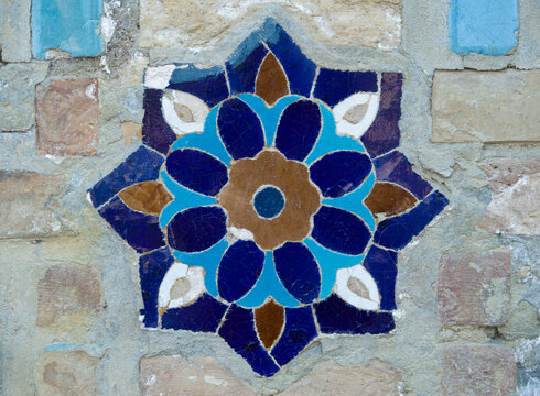 Uzbek ceramic porcelain mosaic with flowers on wall of madrasa in Uzbekistan, Asia