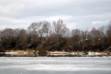 Frozen river bank on a cloudy day