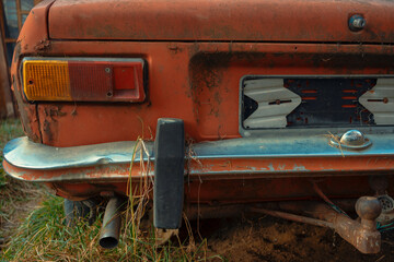 Old broken car from behind