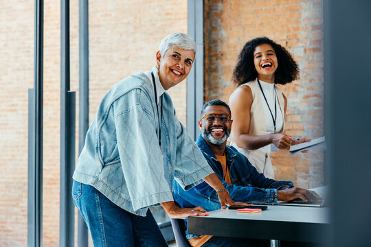 Joyful group of professionals working together in a modern office environment