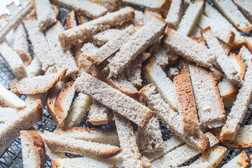 Background with the texture of slices of bread dried on a wire rack. Close-up of crackers or croutons.