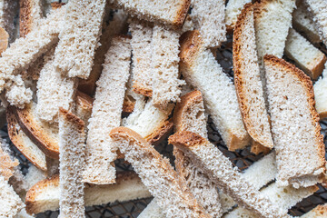 Background with the texture of slices of bread dried on a wire rack. Close-up of crackers or croutons.