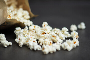 Fresh popcorn in bag made in a microwave on grey kitchen table