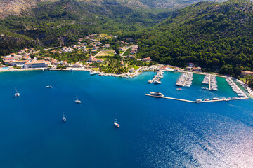 Scenic aerial view many yachts boats moored at Croatian bay harbor shore blue turquoise clear water...