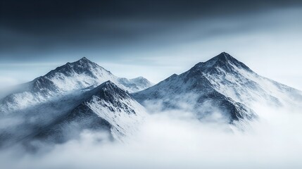 Obraz premium Snow-Capped Mountains Enveloped in Drifting Fog with a Wintery Atmosphere