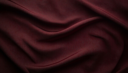 Fototapeta premium A high-resolution, photorealistic image of deep burgundy silk fabric with smooth folds and subtle sheen, set against an isolated dark background. The texture is detailed and realistic, capturing the s