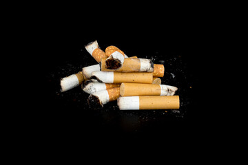 Cigarette butts isolated on black background