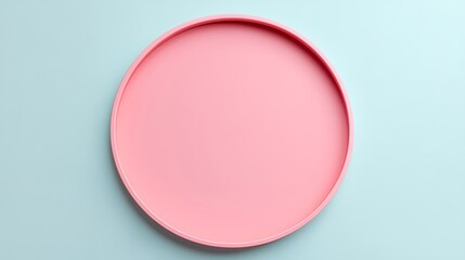 Obraz premium Simple Pink Circular Tray on Light Blue Background for Stylish Home Decor and Minimalist Interior Designs