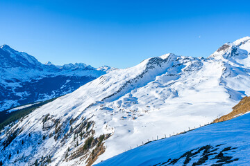 Winter landscape on the First mountain in Swiss Alps in Grindelwald ski resort, Switzerland