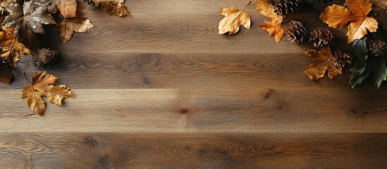Wooden floor in warm brown tones decorated with vibrant orange and yellow leaves on the right side creating a natural aesthetic for interior design