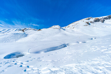 Winter landscape with snow covered peaks seen from the First mountain in Swiss Alps in Grindelwald,...