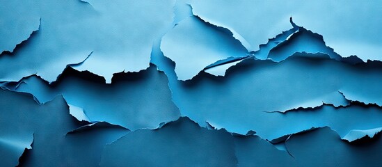 Obraz premium Torn blue paper background displaying layered textures with varying shades of blue creating depth and aesthetic appeal for design projects