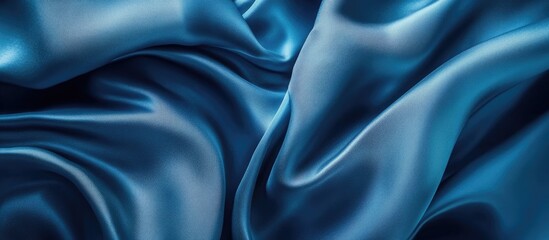Obraz premium Satin fabric in rich blue tones with soft folds and reflective texture creating ample copy space for website banner design