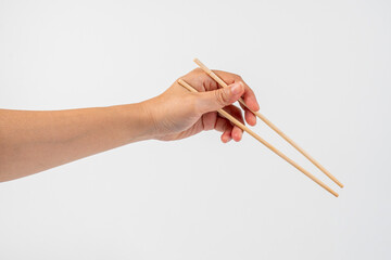 Wood chopsticks for rice and hand on a white background