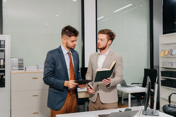 Business team working on a project in the office or reviewing and discussing a business project.
