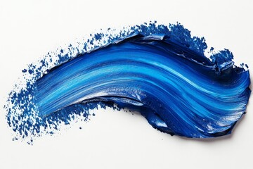 Swirls of vibrant blue paint create an artistic wave on a crisp white background during a creative studio session