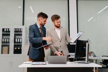 Diverse professionals collaborate on project analysis with financial graphs. Strategic teamwork and insights drive company growth and success.