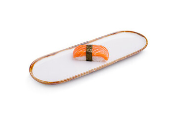 Salmon nigiri served on a simple white plate in a minimalist setting