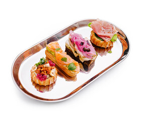 Delicious assortment of gourmet appetizers arranged on a metal platter in a stylish setting