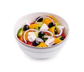 Fresh vegetable and feta cheese salad with olives served in a white bowl