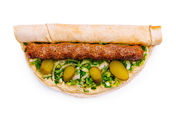 Delicious wrap filled with grilled meat, fresh vegetables, and pickles on flatbread