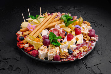 Exquisite charcuterie platter featuring a variety of cheeses, meats, fruits, and nuts displayed elegantly for a festive gathering