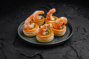 Delicious shrimp appetizers on flaky pastry served on a modern plate