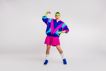 Energetic young man in vibrant retro sportswear posing confidently for a dynamic workout photo on a...