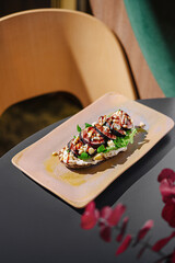 Delicious grilled vegetable dish served on a rustic plate in a modern dining space with natural light