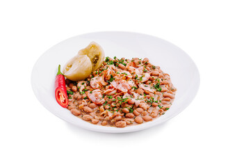 Savory plate of seasoned pinto beans garnished with fresh herbs and peppers served on a white background