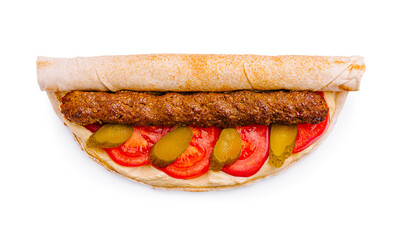 Delicious wrap filled with grilled meat, fresh vegetables, and creamy sauce served on a white background